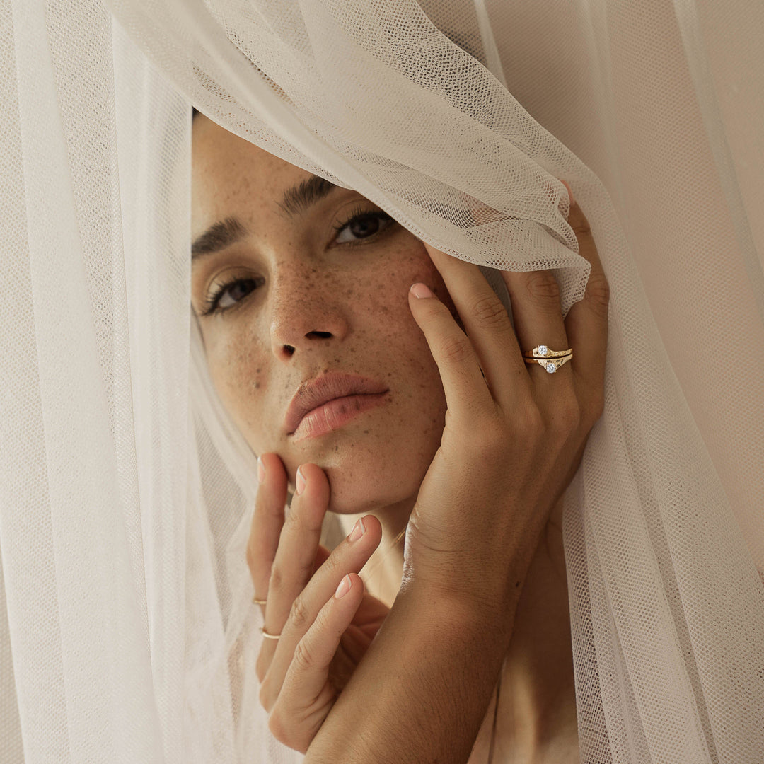 A woman wearing Ienissei rings by Scéona fine jewellery