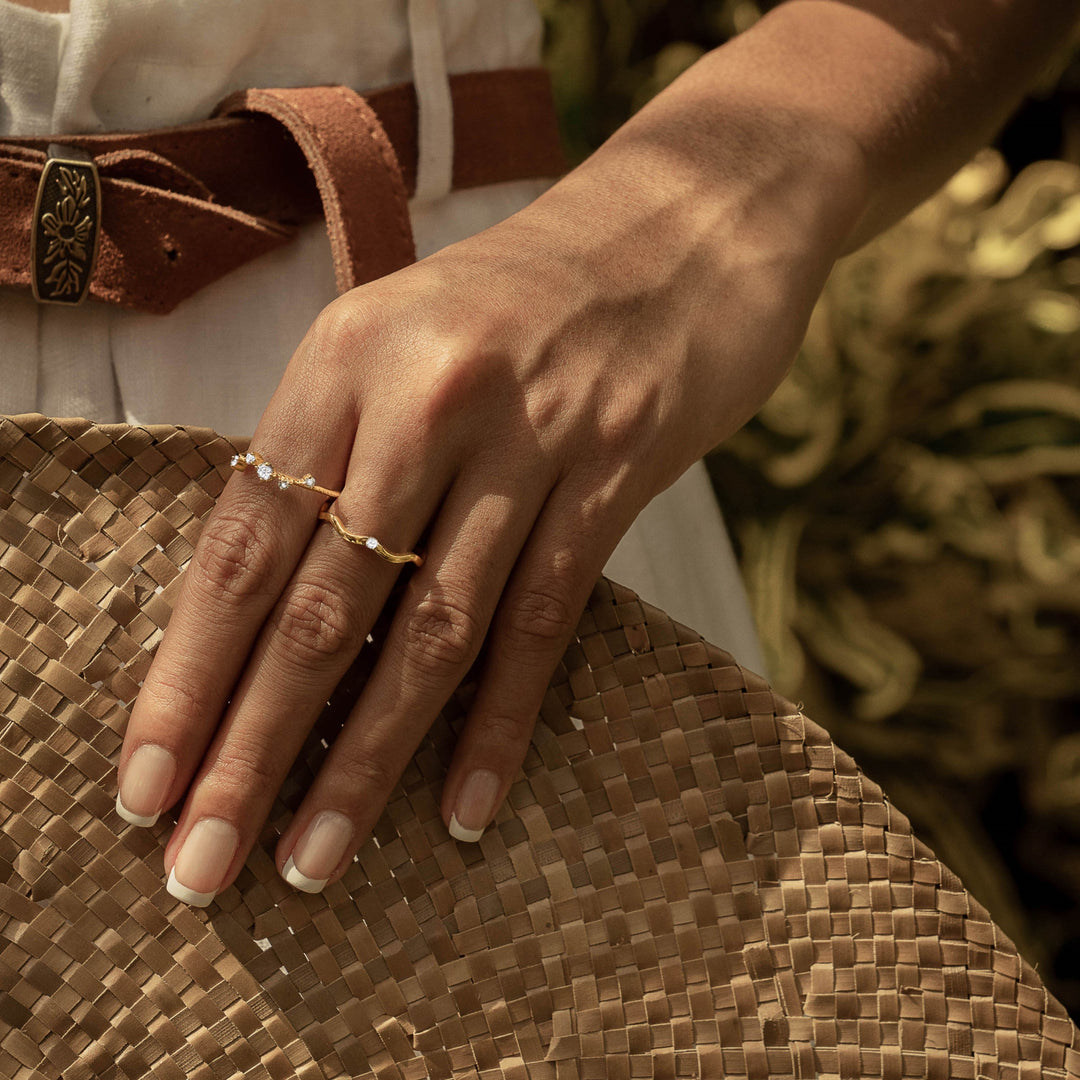 A woman wearing 2 rings created by Sceona, Kasai ring and Anadyr ring